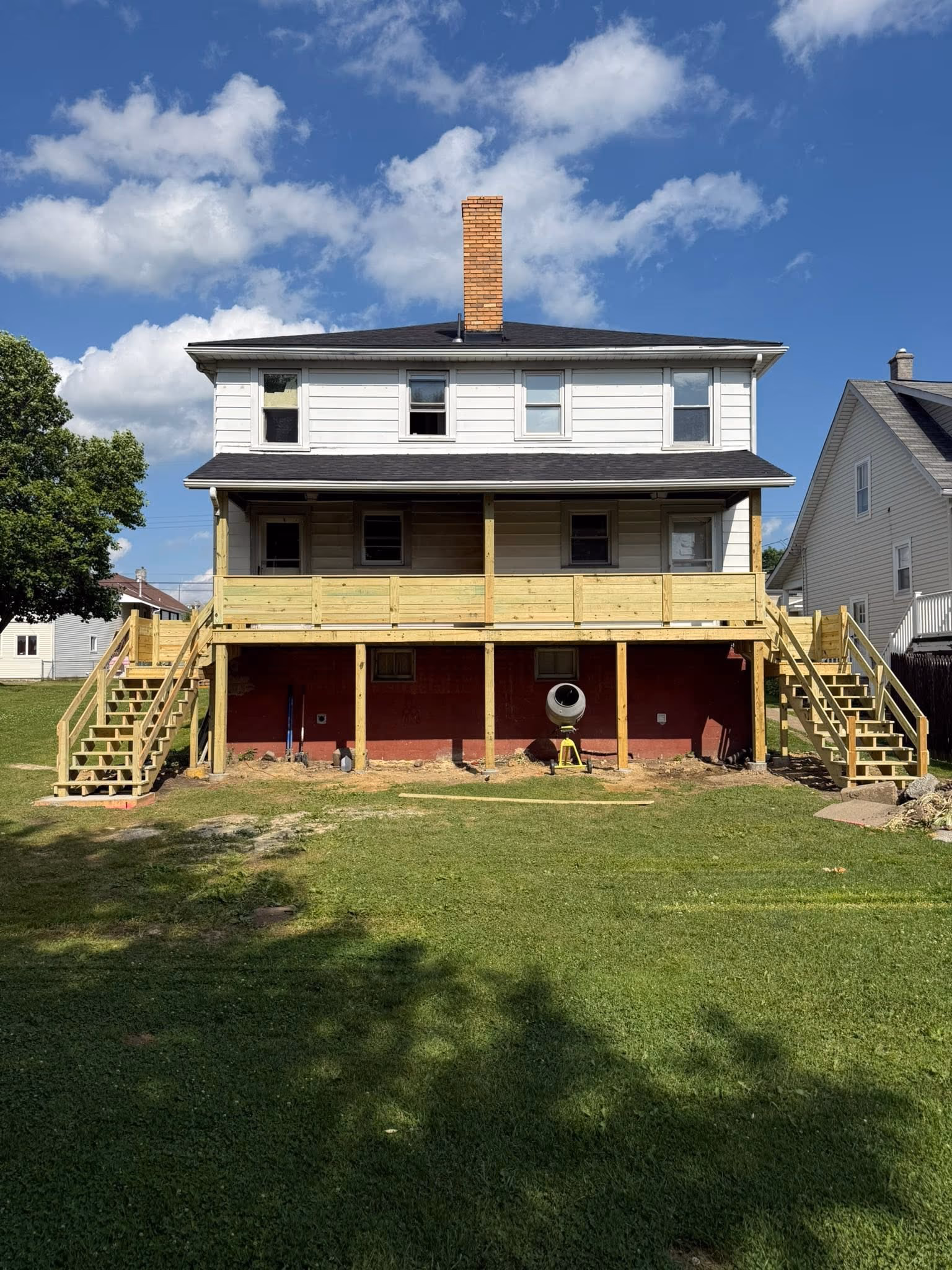 Front-on view of a new full-width covered rear porch and deck