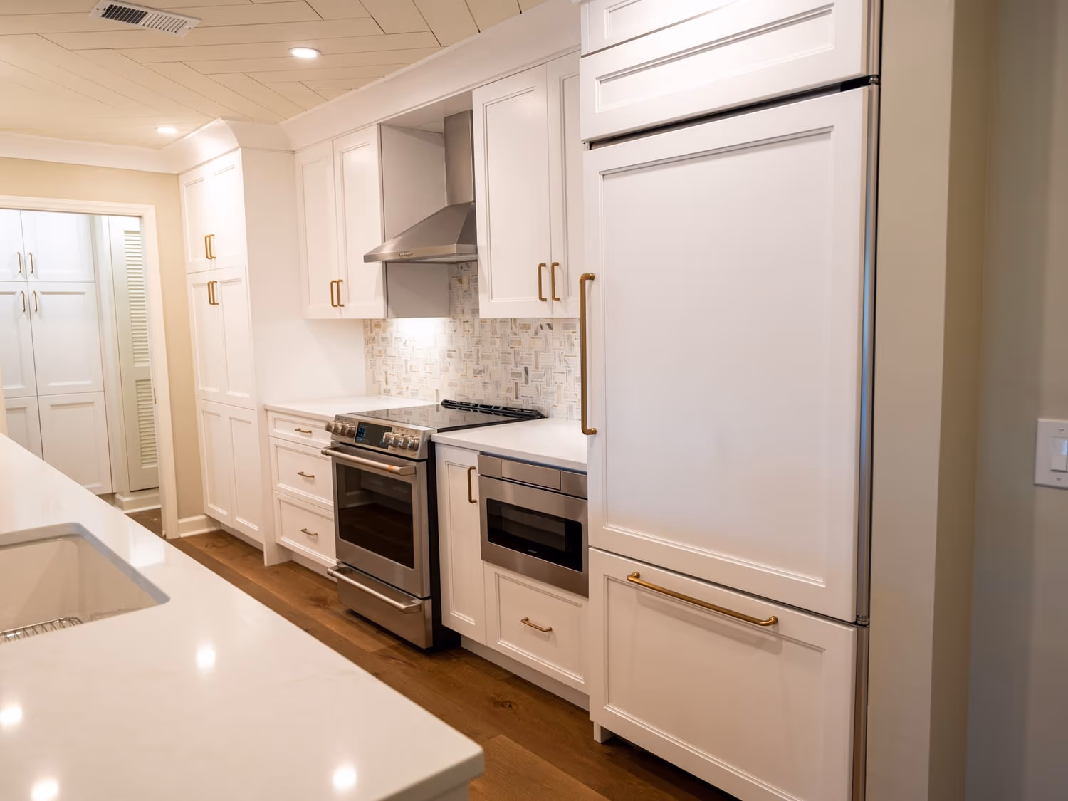 White kitchen cabinetry with stainless appliances