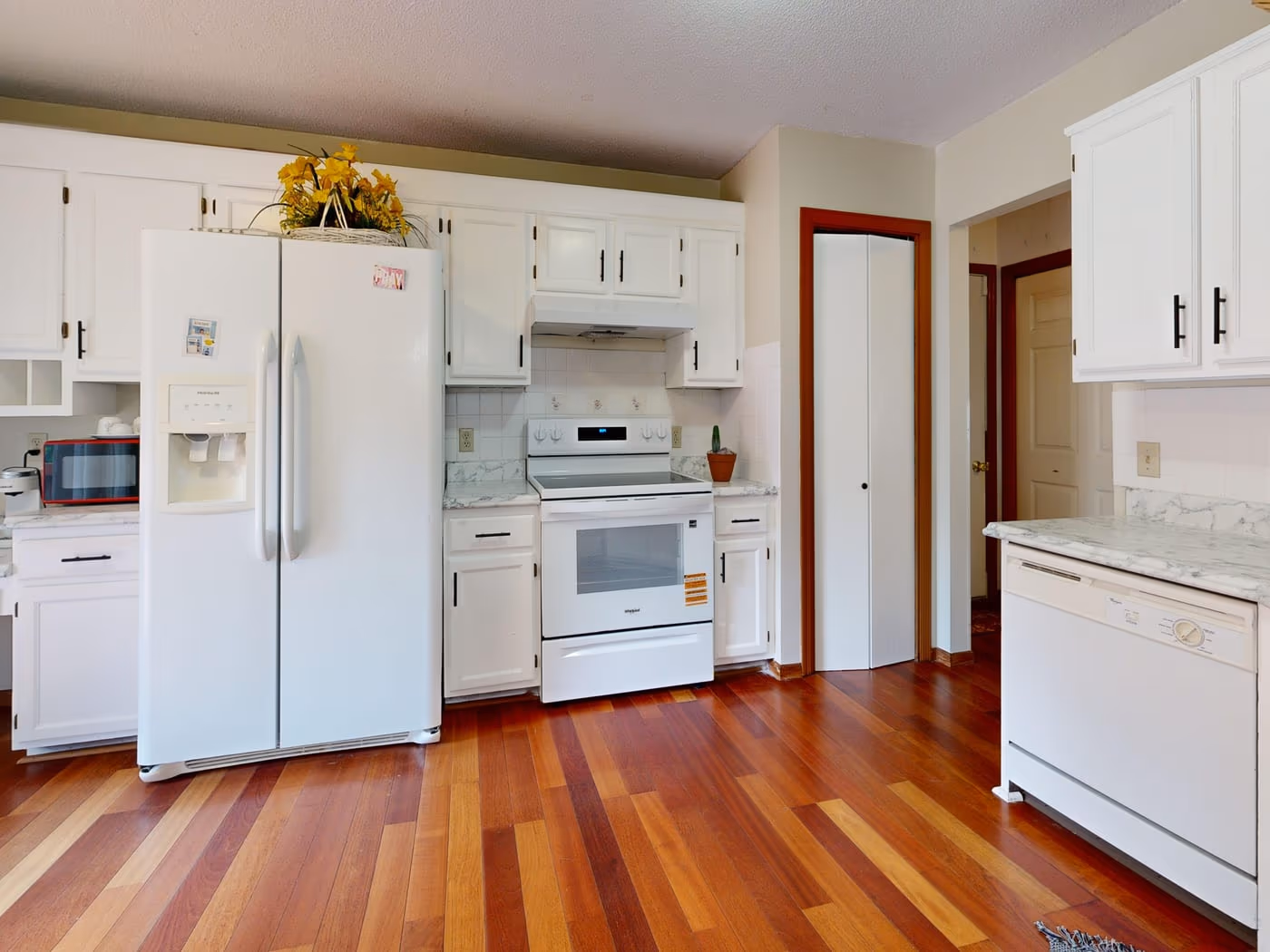 Bright white kitchen with wood-look flooring