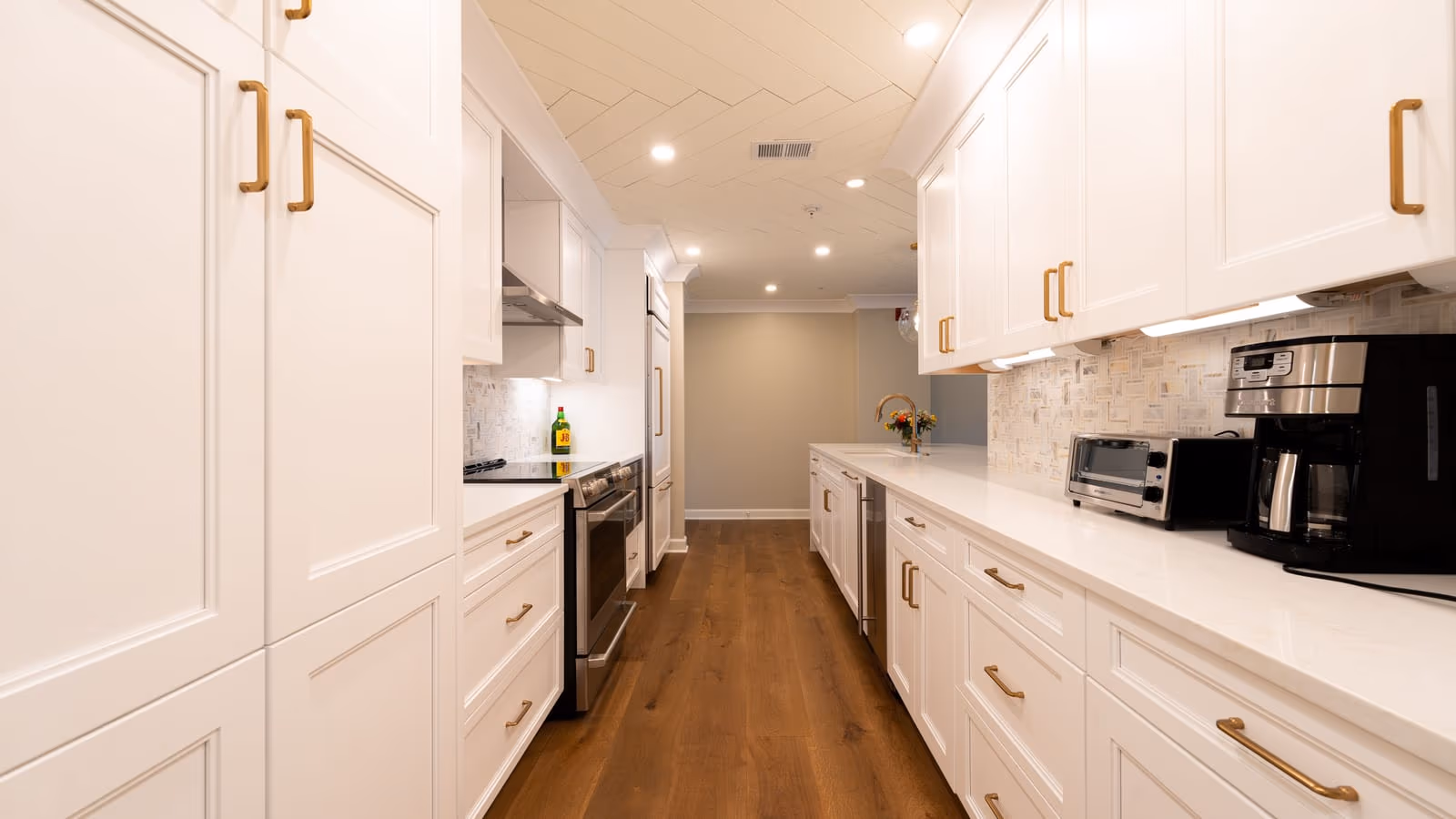 Modern white kitchen with a wood-look floor