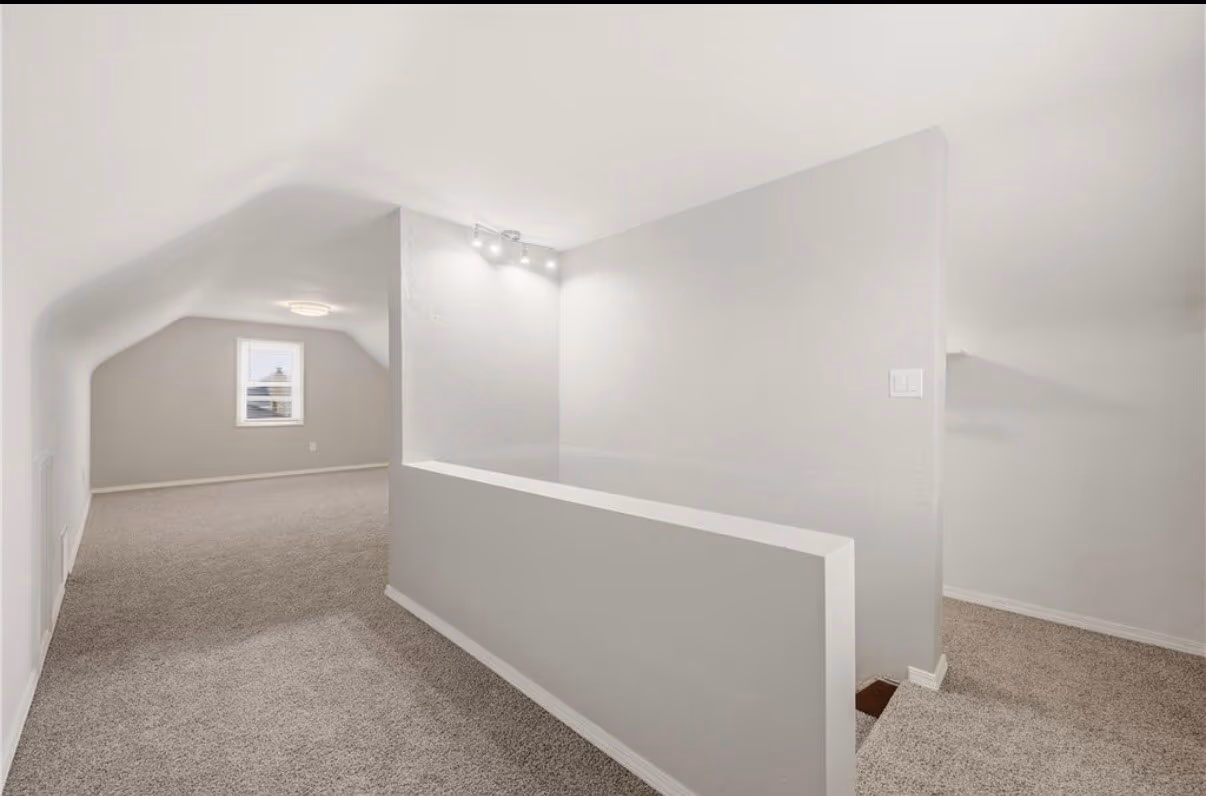 Finished upper-level loft landing with carpet and fresh paint