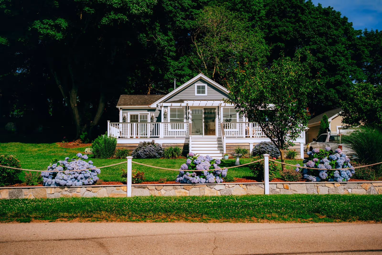 Stone retaining wall running along the front of a house